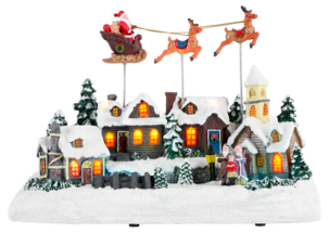 Jouluinen kylä, jossa joulupukki, poroja ja reki
