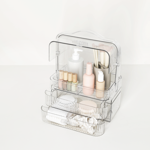 Bærbart sminkeskrin med skuffer i gjennomsiktig plast